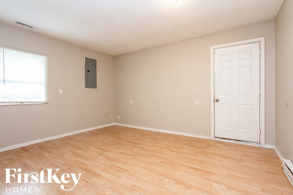 A room with a white door and a window with a FirstKey Homes logo.