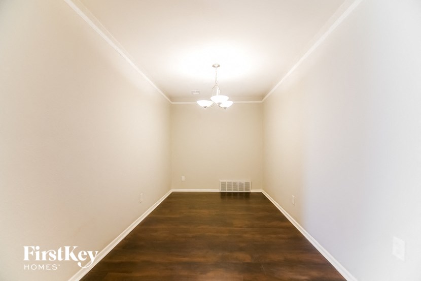 a empty room with a wood floor and white walls