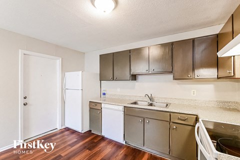 a kitchen with stainless steel appliances and a white refrigerator