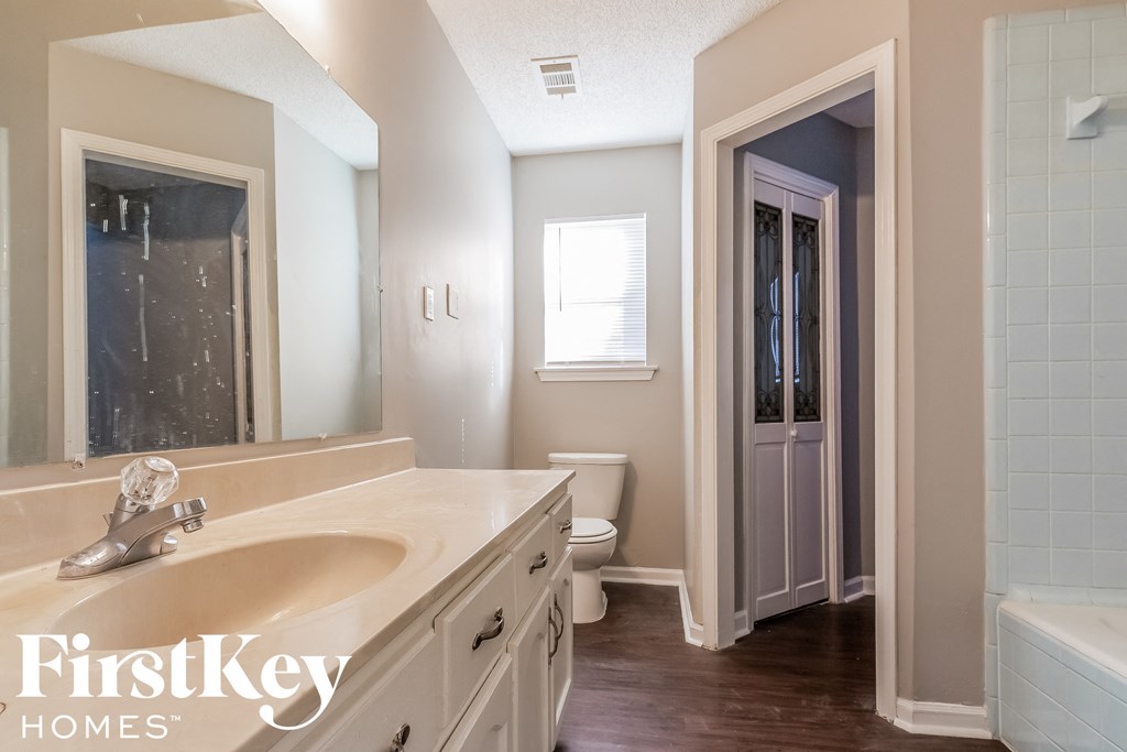 a bathroom with a sink and a toilet and a shower