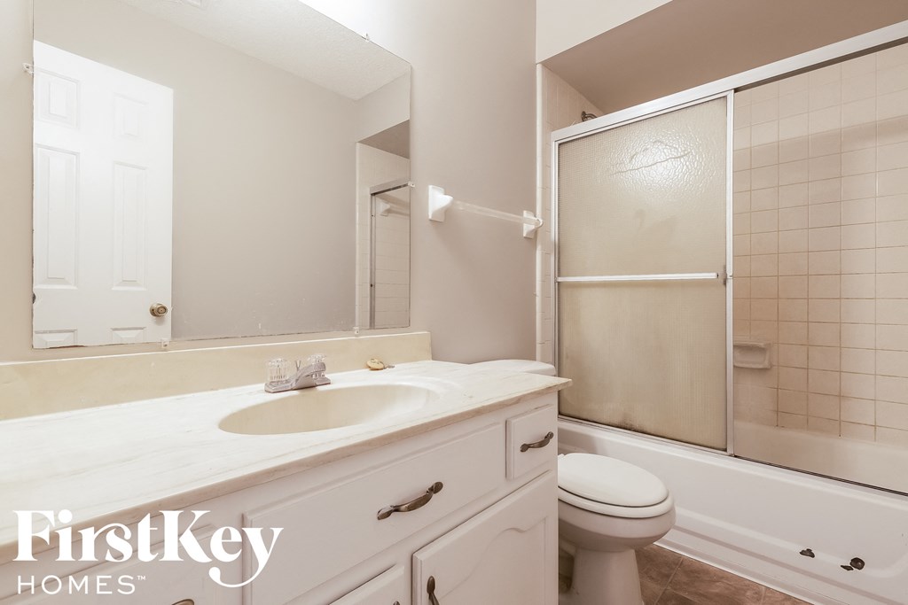 a bathroom with a sink and a toilet and a shower