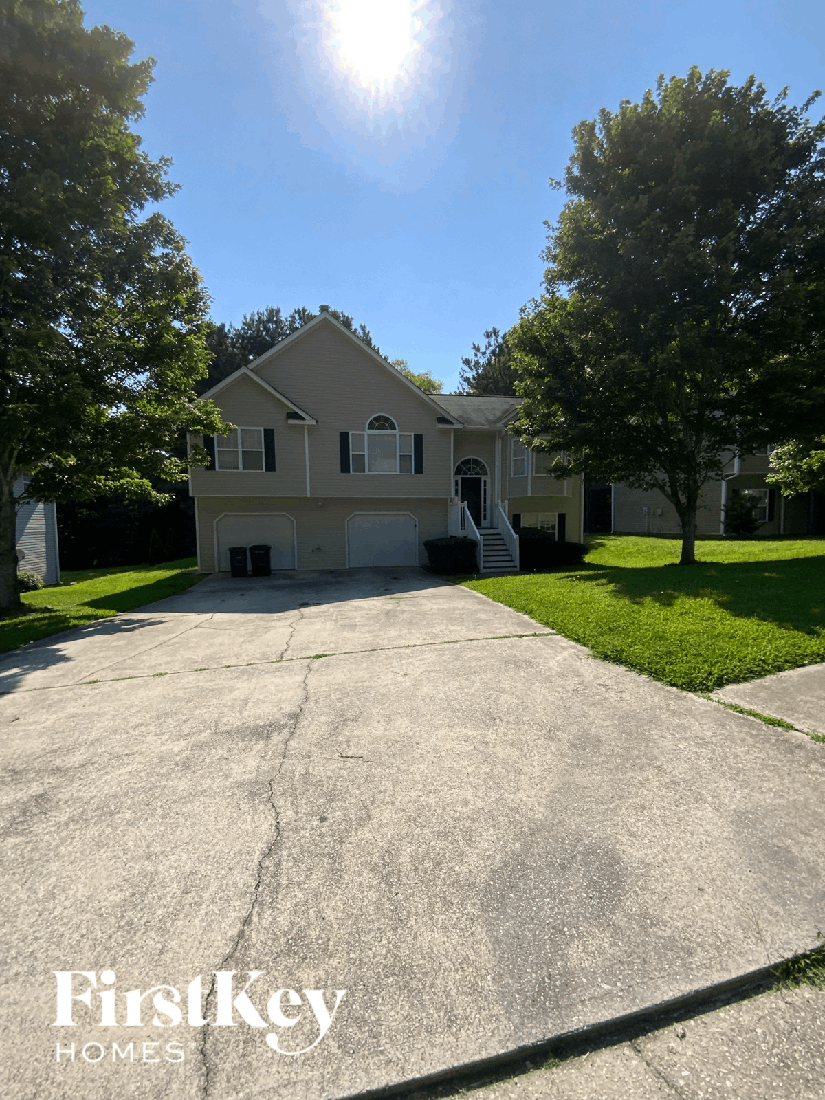A house with a driveway in front of it.