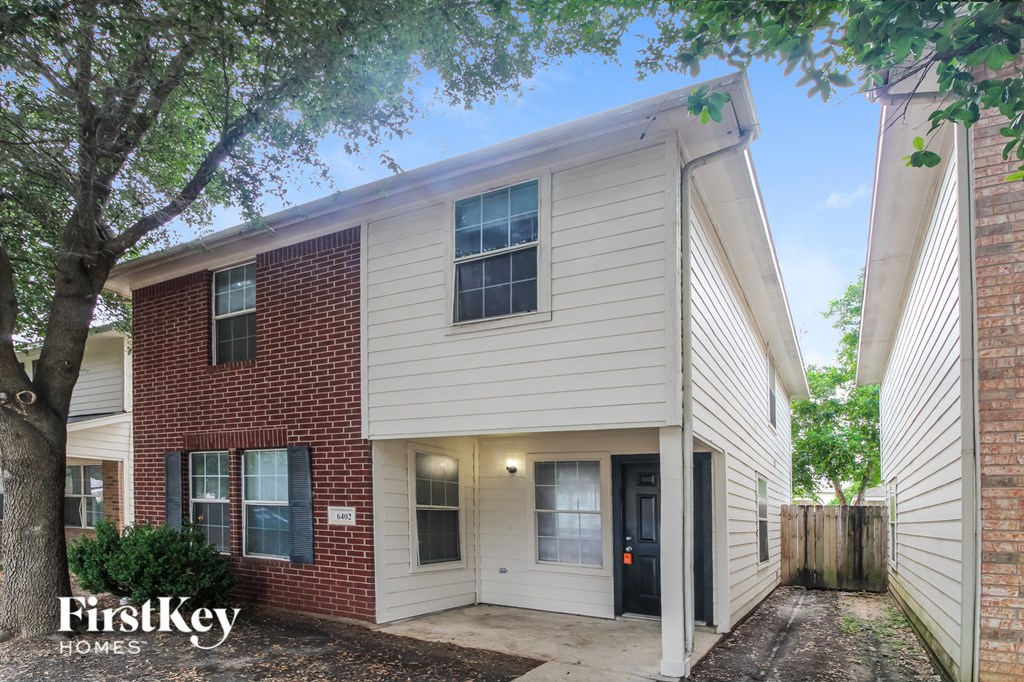 the exterior of a brick and with a sidewalk