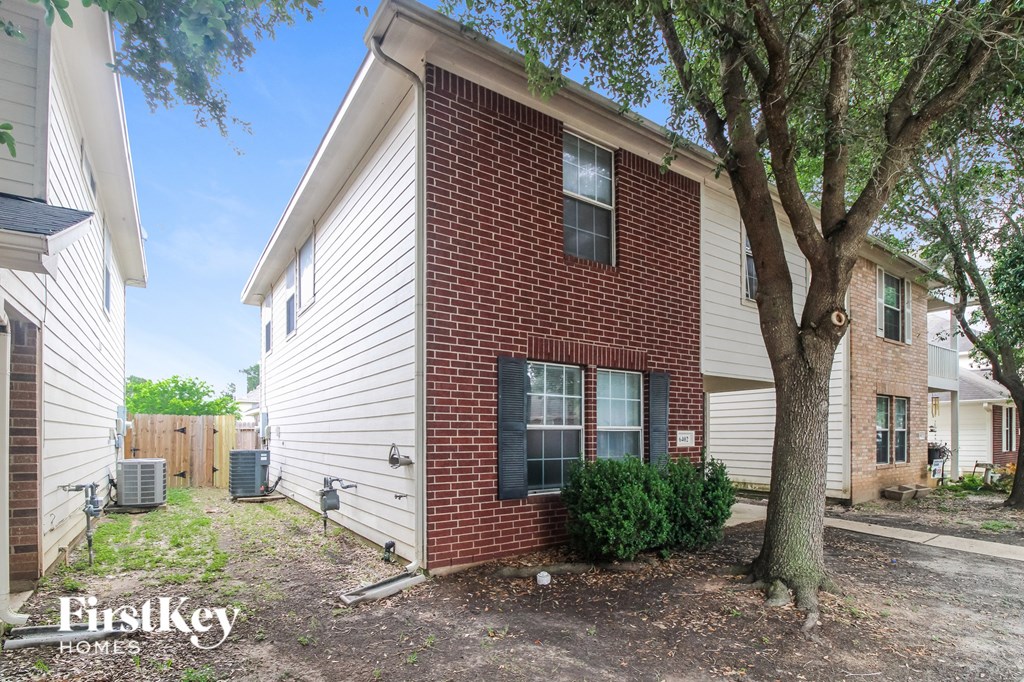 a brick and with a tree in the yard
