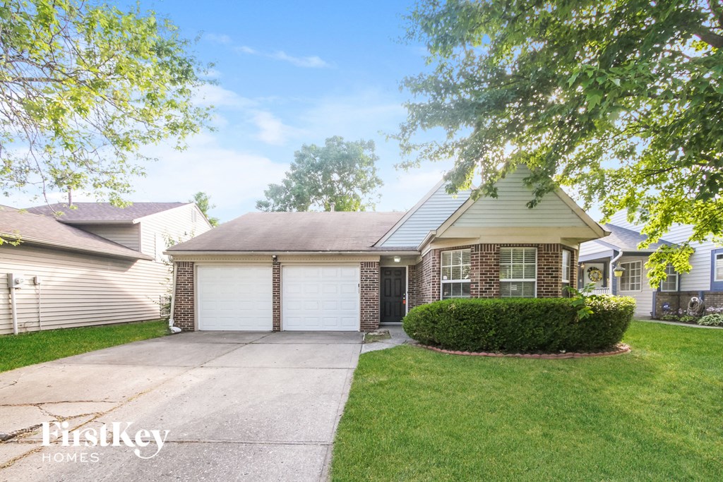 a home with a driveway and a white garage door