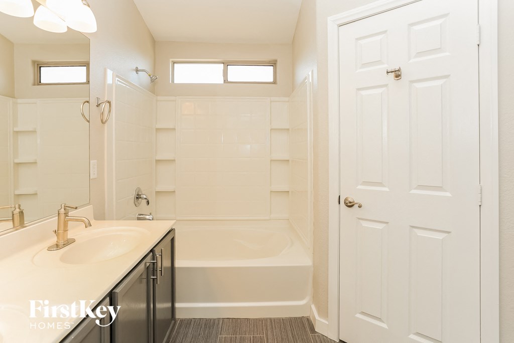 a bathroom with a sink and a tub and a shower
