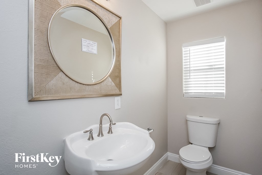 a bathroom with a sink and a mirror and a toilet