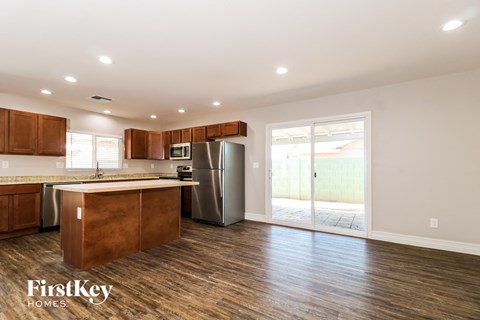 A kitchen with wooden cabinets and a refrigerator.