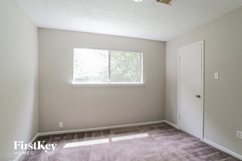 a empty room with a window and a door