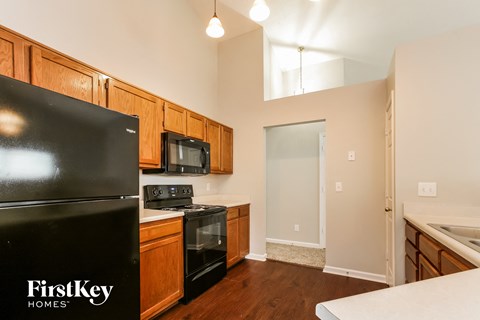 a kitchen with black appliances and wooden cabinets
