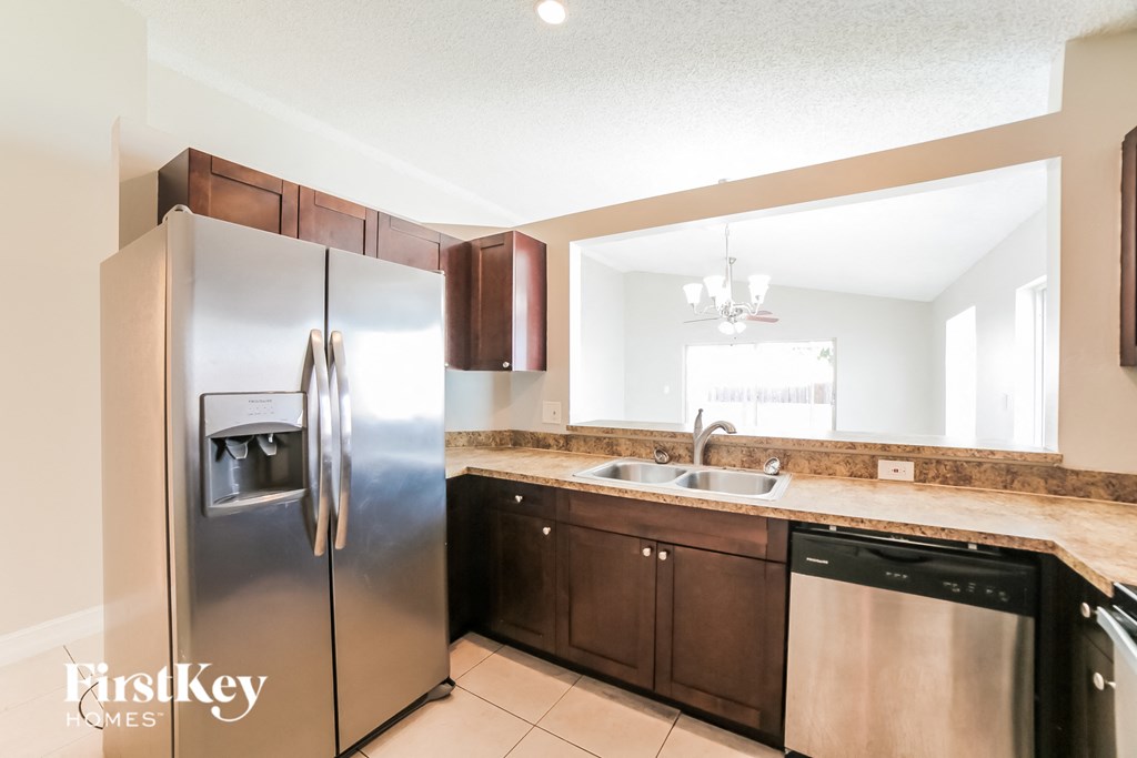 a kitchen with stainless steel appliances and wooden cabinets