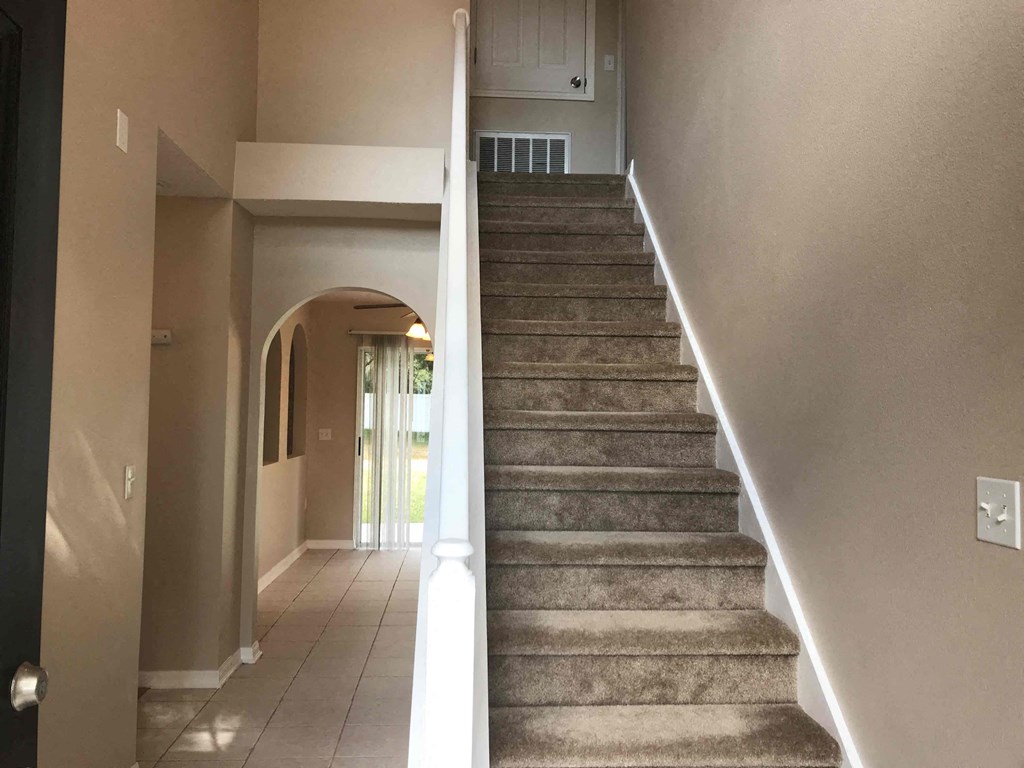 A staircase with a light on the side.