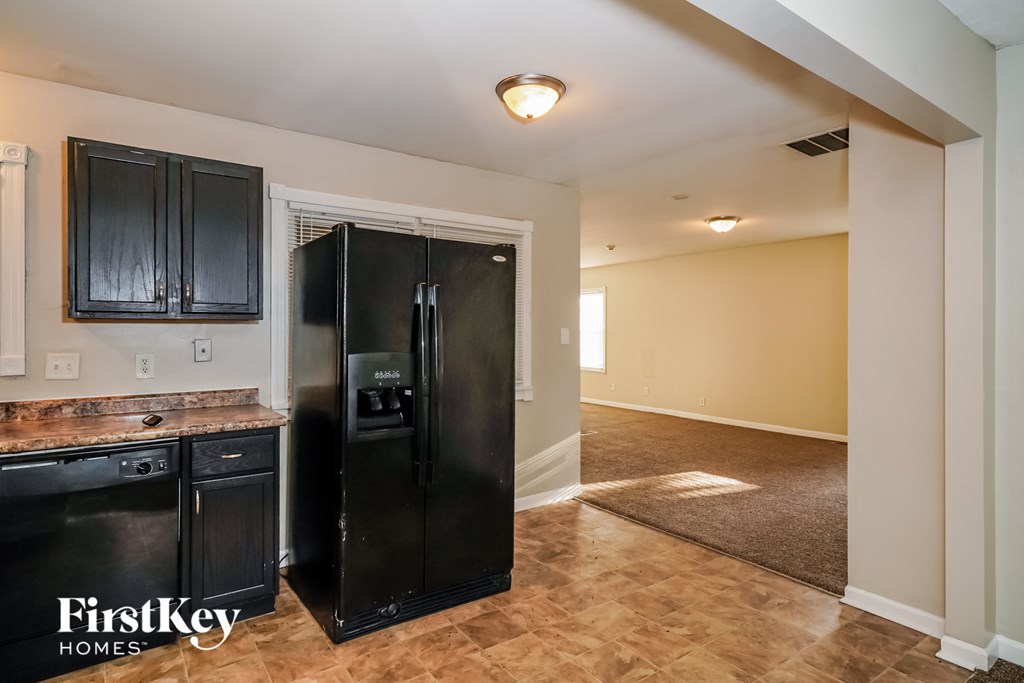 the kitchen is open to the living room and laundry room