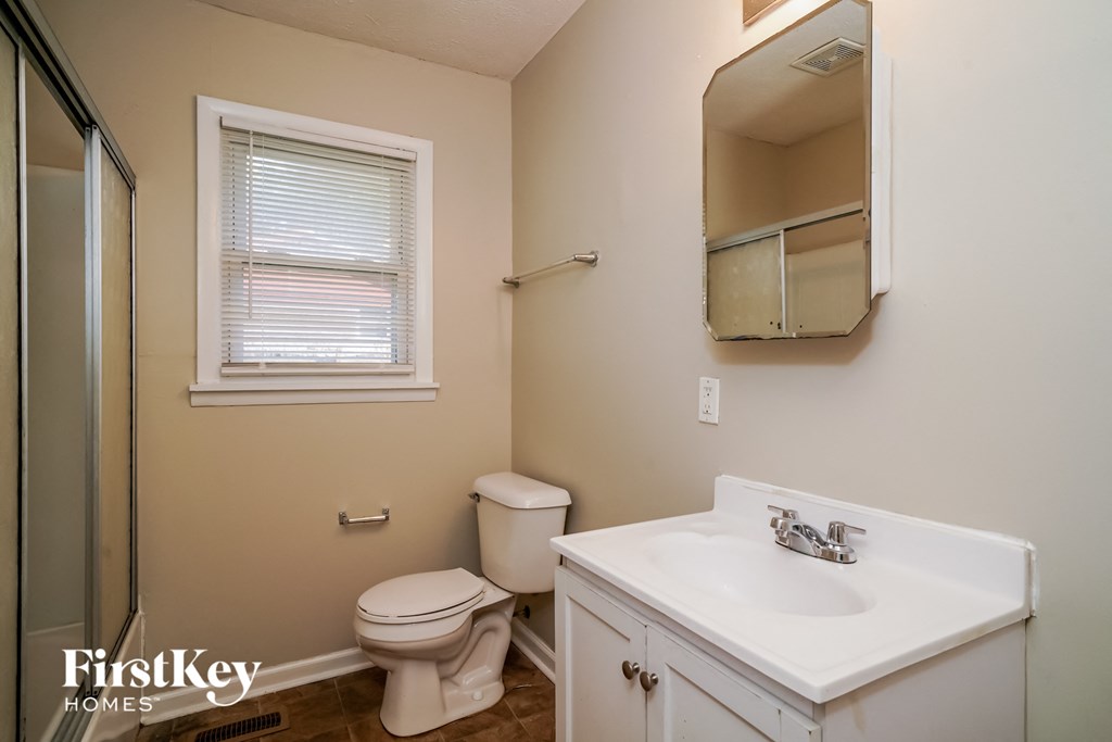 a bathroom with a sink toilet and a shower