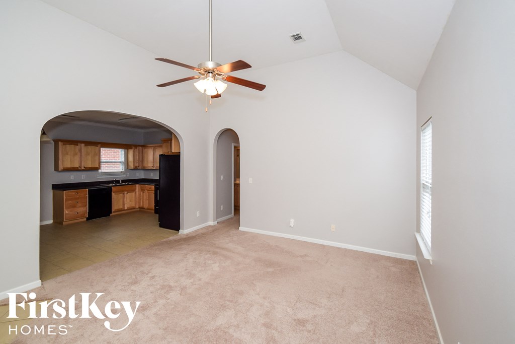 A spacious room with a fan and a window.