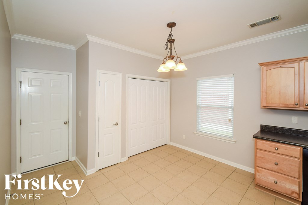A room with a light brown floor and a light brown cabinet.