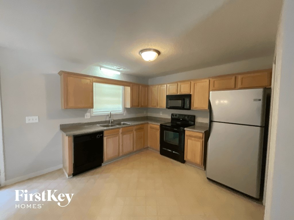 A kitchen with wooden cabinets and stainless steel appliances.