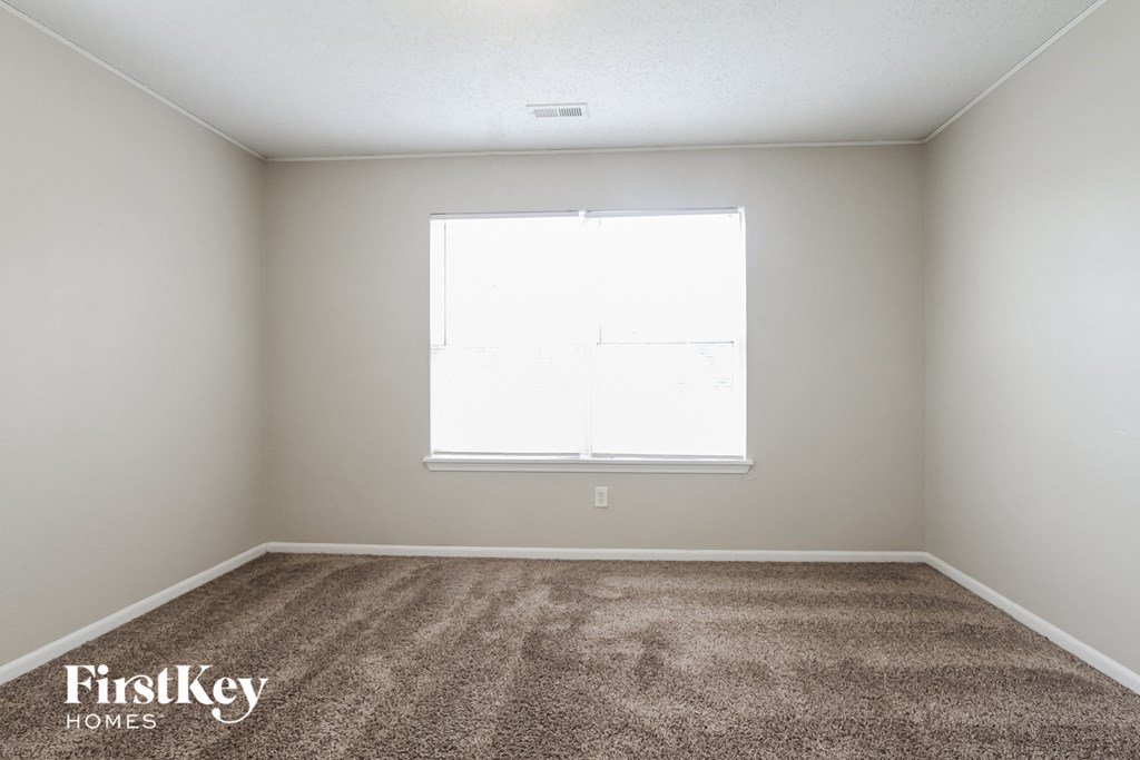 a room with carpet and a window