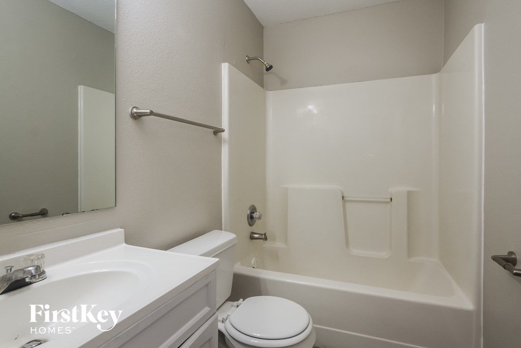 a bathroom with a sink toilet and a bath tub