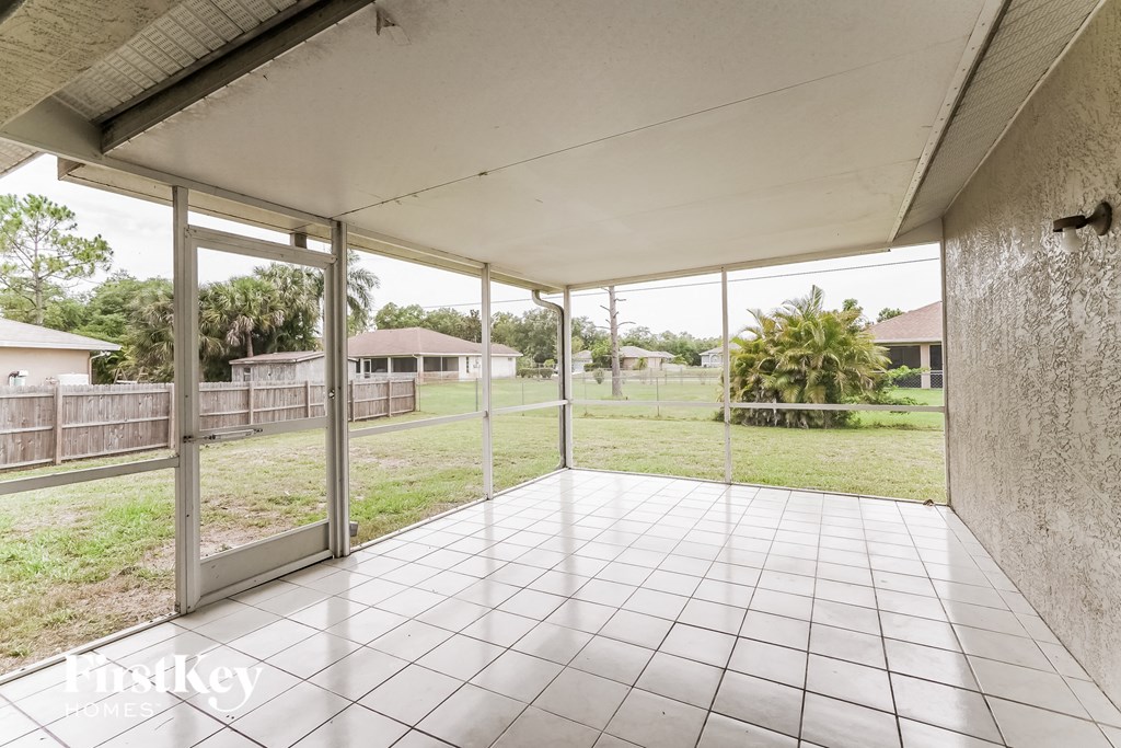 a patio with glass doors and a white tiled floor