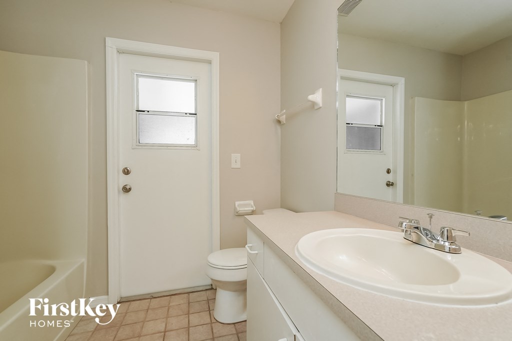 a bathroom with a sink and a toilet and a mirror