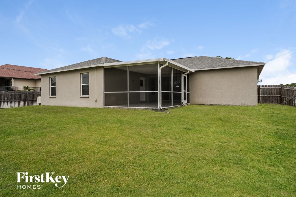 a home with a patio and a grass yard