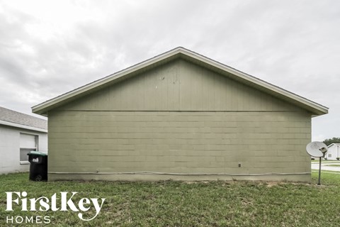 A small building with a satellite dish on the side.