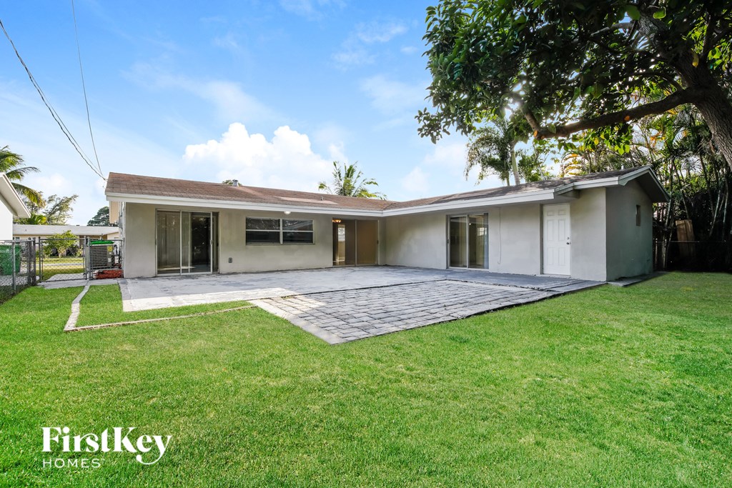 a white house with a yard and a driveway