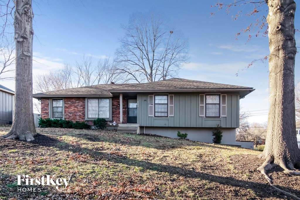 a green house with two trees in front of it