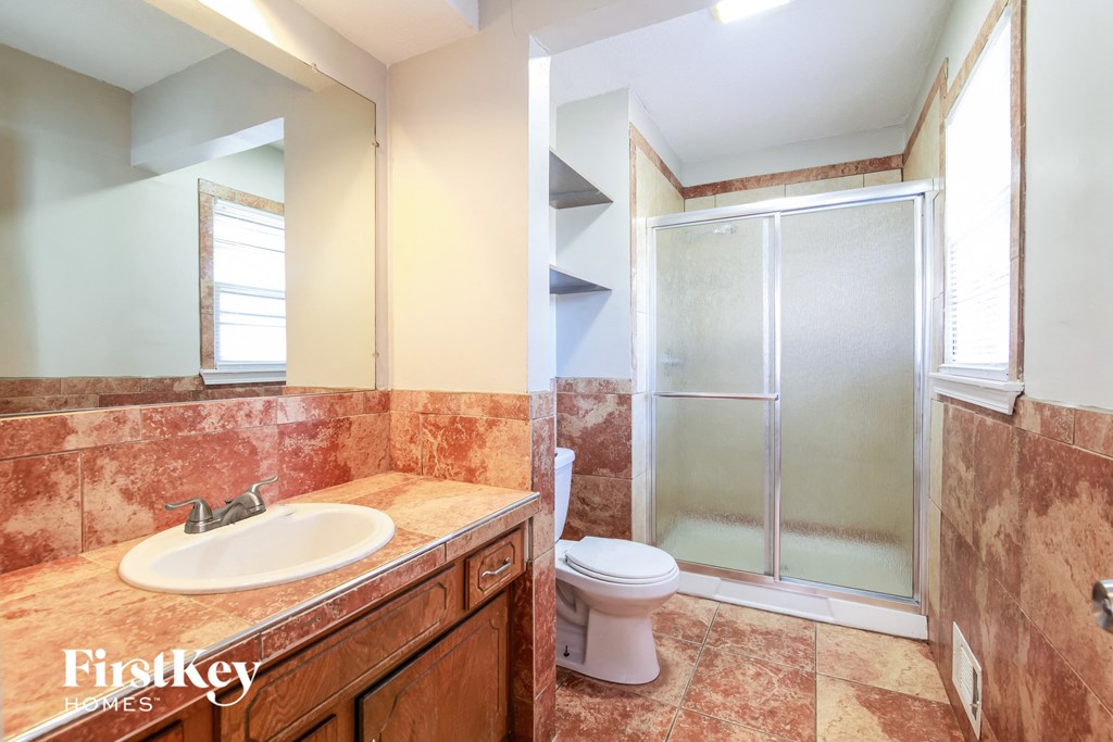 a bathroom with a sink toilet and a shower