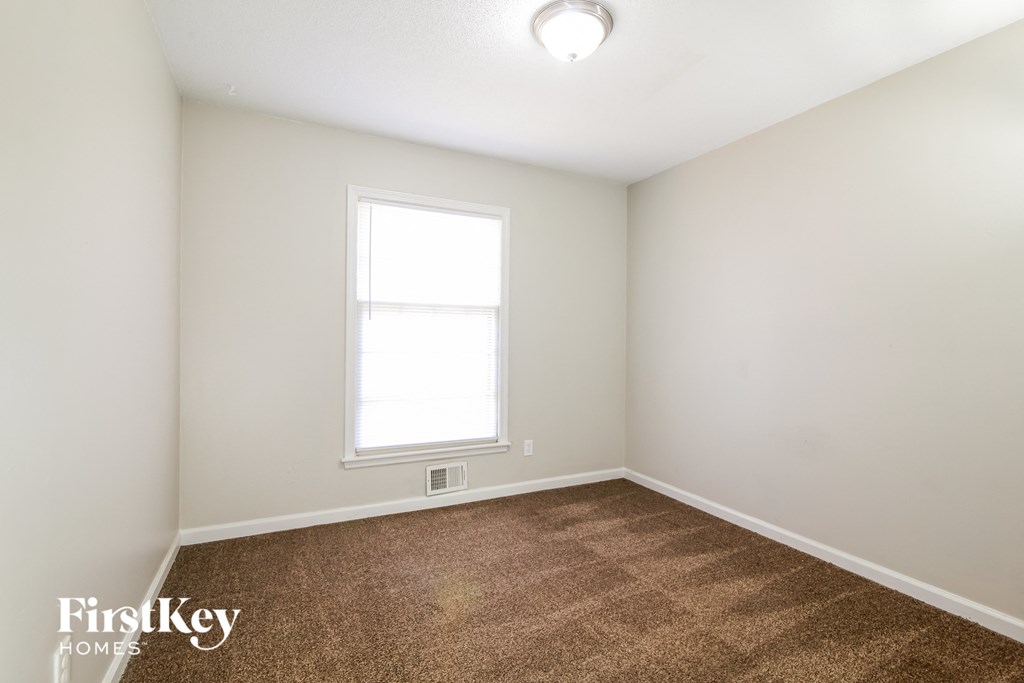 a room with a carpeted floor and a window