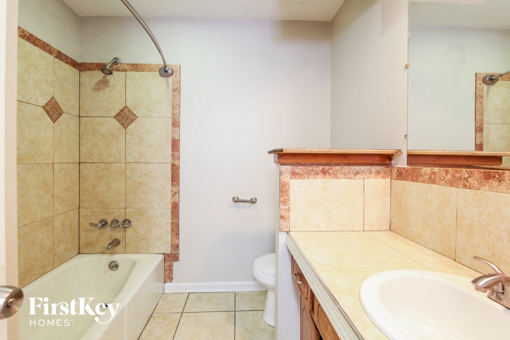 a bathroom with a sink and a shower and a toilet