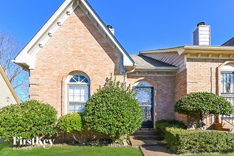 a brick house with a blue sky in the background