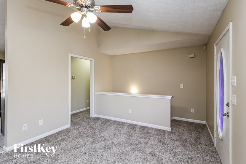 the upstairs bonus room is spacious and has a ceiling fan