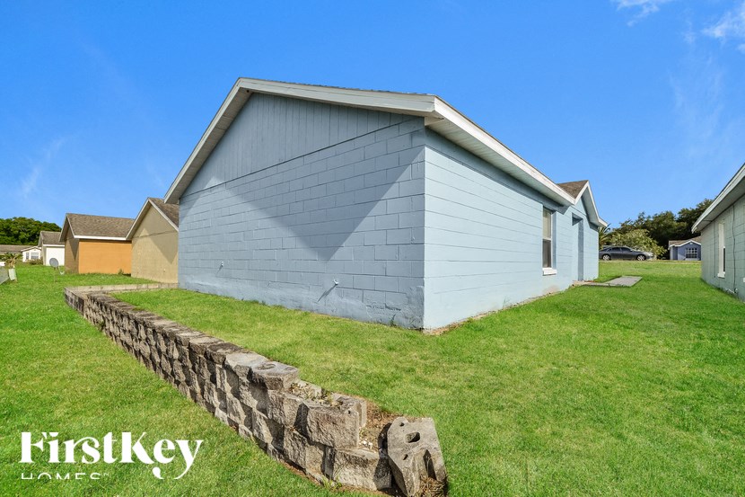 a house with a stone retaining wall in front of it