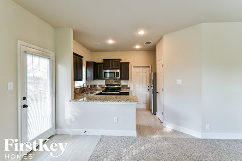 the kitchen is open to the living room and dining room