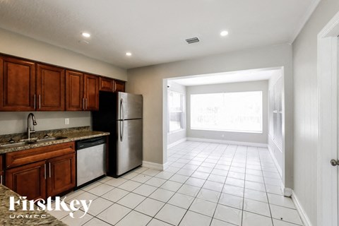 a kitchen with a stainless steel refrigerator and a sink