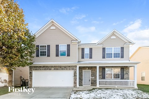 a beige house with a white garage door
