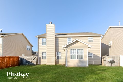 a row of houses with a grassy yard in front of them