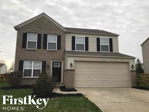 a house with a driveway and a garage door