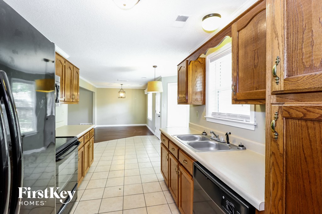 a kitchen with wooden cabinets and a stainless steel sink