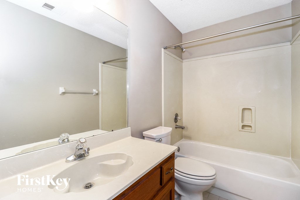 a bathroom with a sink and a toilet and a tub