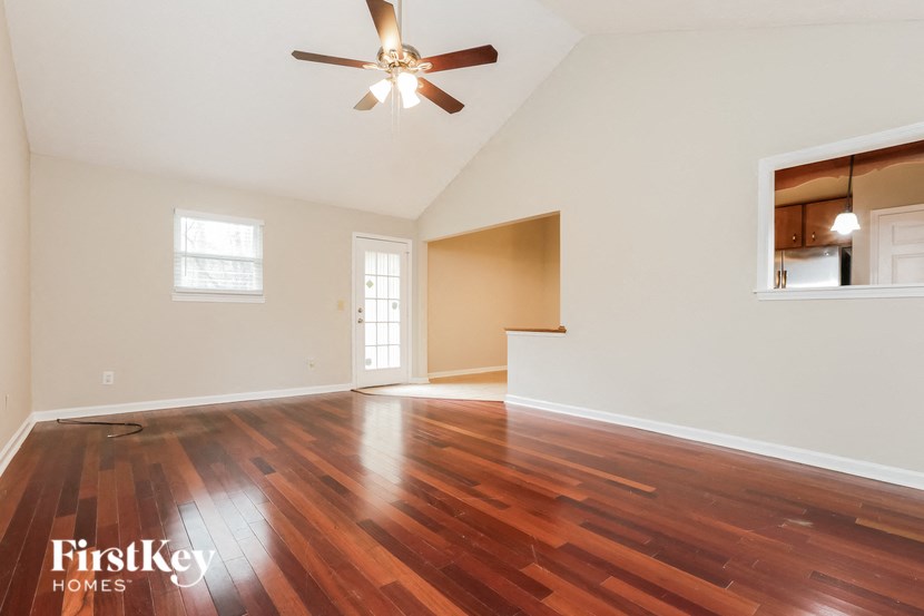 A room with wooden floors and a ceiling fan.