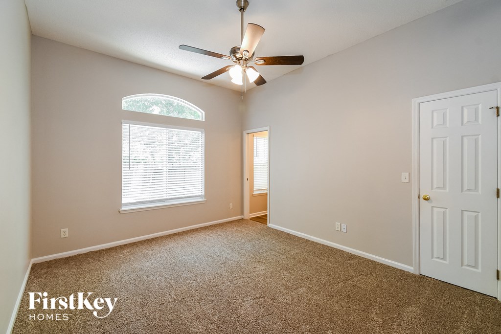 the master bedroom is spacious and has a ceiling fan