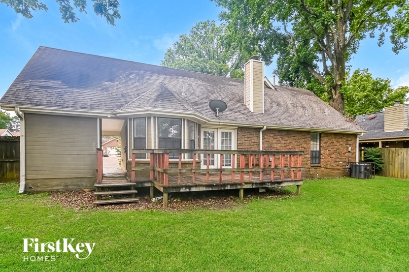 a house with a deck on the front of it