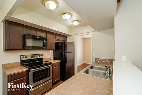 a kitchen with stainless steel appliances and wooden cabinets