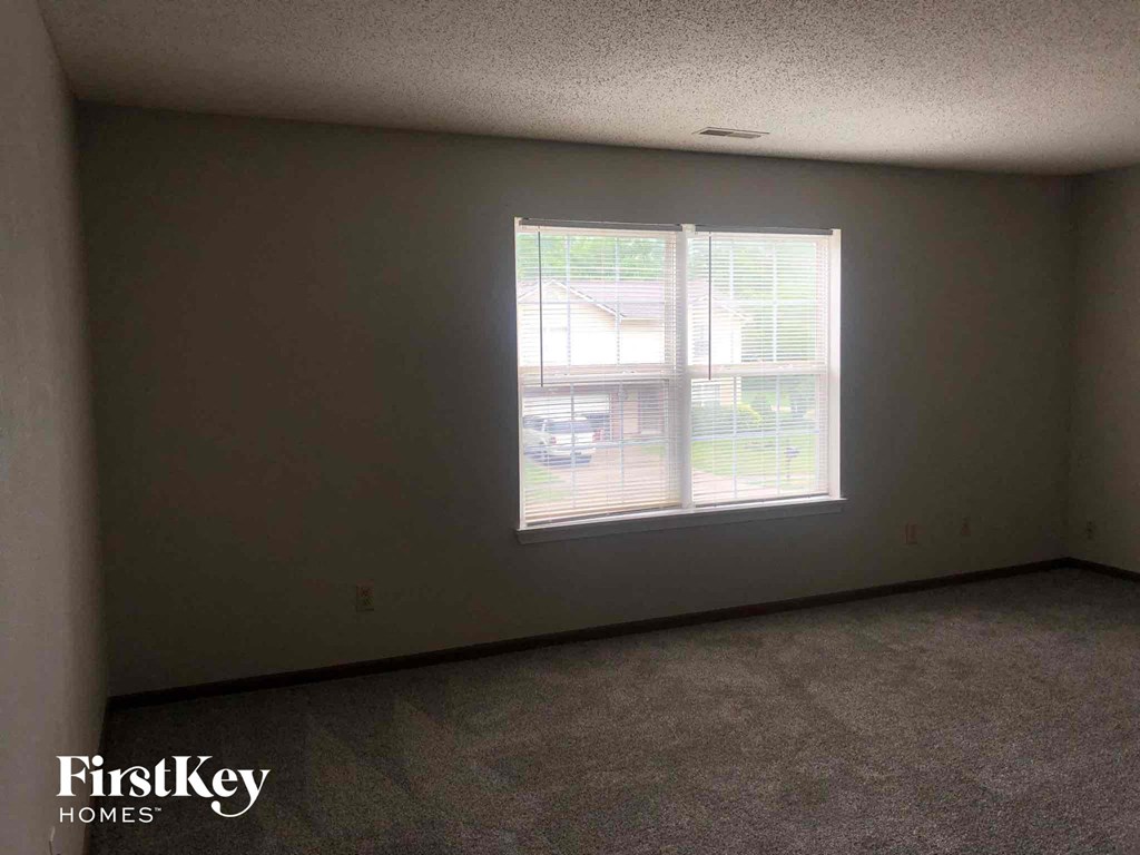 an empty living room with a large window