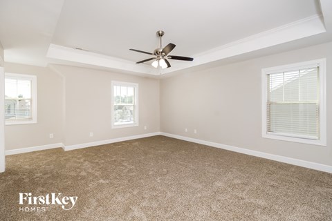 a bedroom with carpet and a ceiling fan