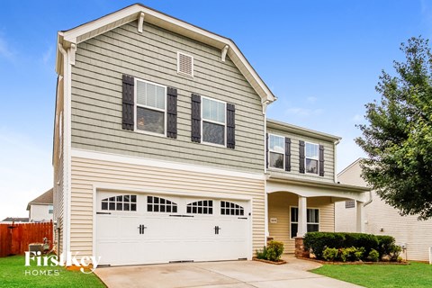 a tan house with a white garage door