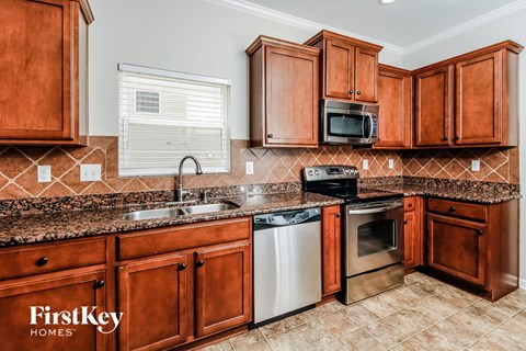 a kitchen with wooden cabinets and granite counter tops